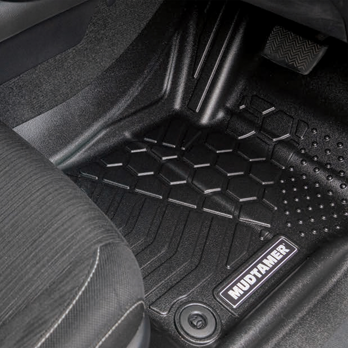 Front driver's side MUDTAMER floor mat installed in a Toyota Hilux